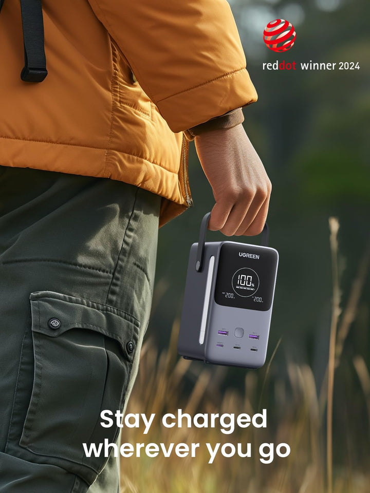 Person Holding UGREEN 300W 48000mAh Power Bank  in Outdoor Setting: Stay Charged Wherever You Go